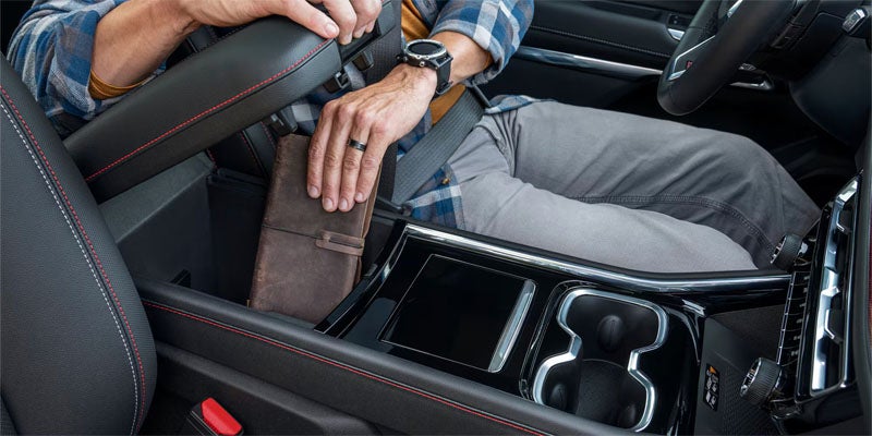 Driver placing item in center console of 2026 Chevrolet Traverse in Orangeburg SC